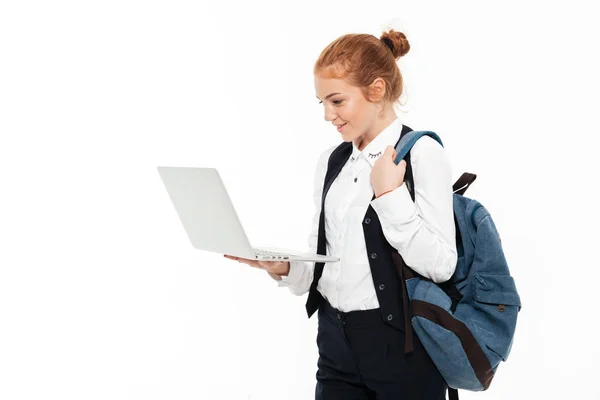 Mulher estudante feliz gigner com mochila segurando computador portátil — Fotografia de Stock