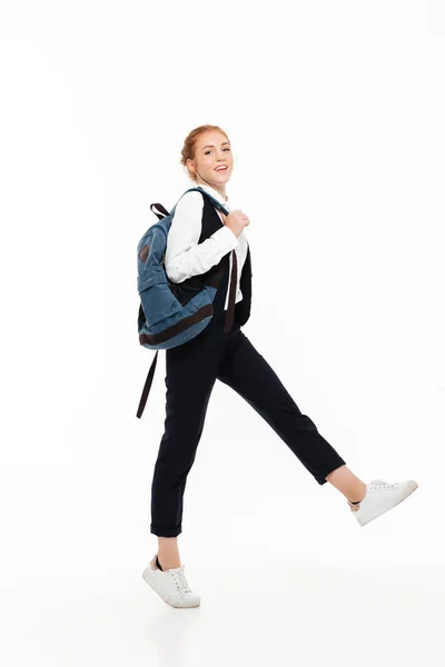 Full length image of pleased gigner student woman with backpack — Stockfoto