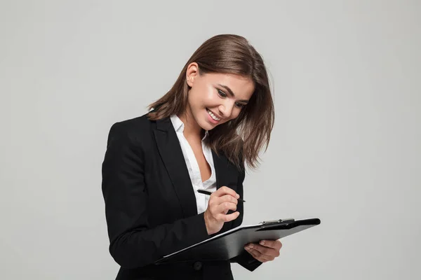 Portrait of a pretty satisfied businesswoman in suit — Stock Photo, Image