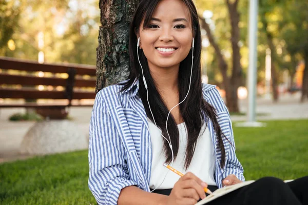 Close-up van de mooie Aziatische vrouwelijke student, luisteren naar muziek, l — Stockfoto