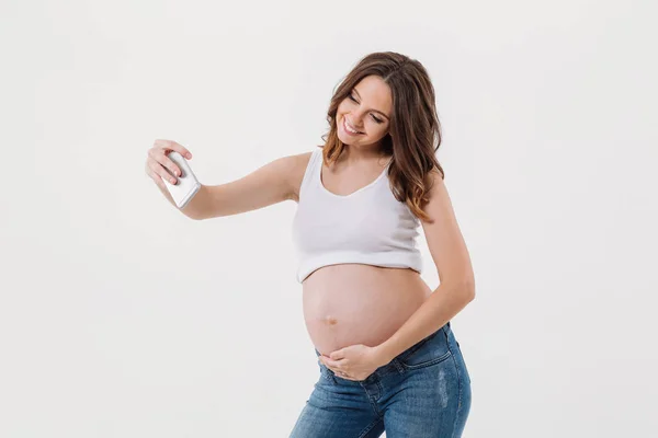 Happy pregnant woman make selfie with her belly — Stock Photo, Image