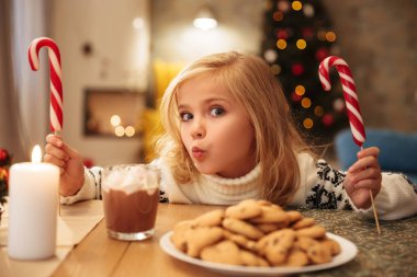 Sevimli küçük kız görürken iki şekerler ile şenlikli 