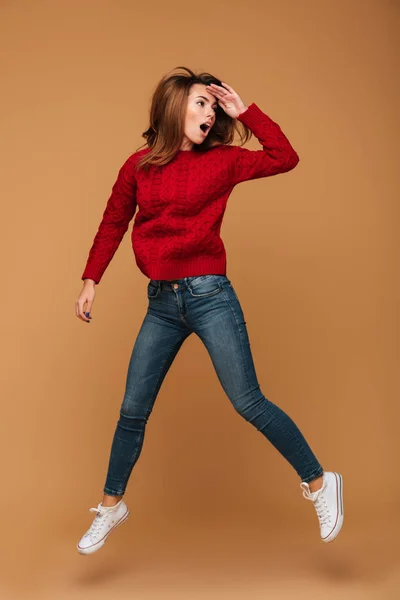 Full length portrait of amazed pretty brunette woman in red knit — Stock Photo, Image