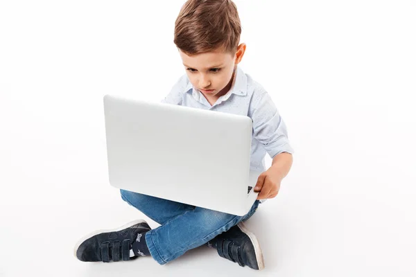 Portrait of a cute little kid using laptop computer — Stock Photo, Image