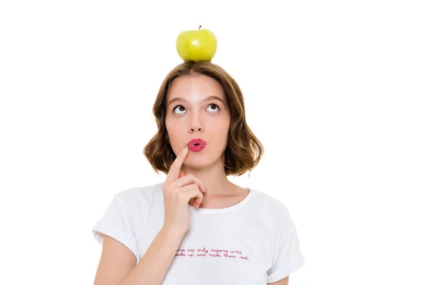 Thinking pretty caucasian woman holding apple on head — Stock Photo, Image