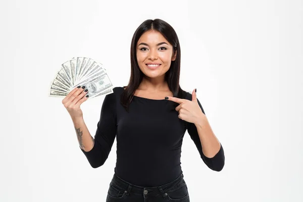 Asian woman standing isolated holding money pointing. — Stock Photo, Image