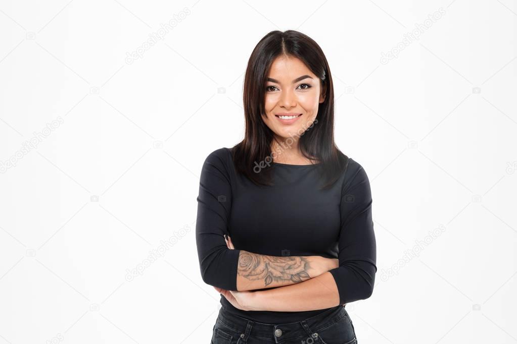 Pretty young asian lady with arms crossed. Looking camera.