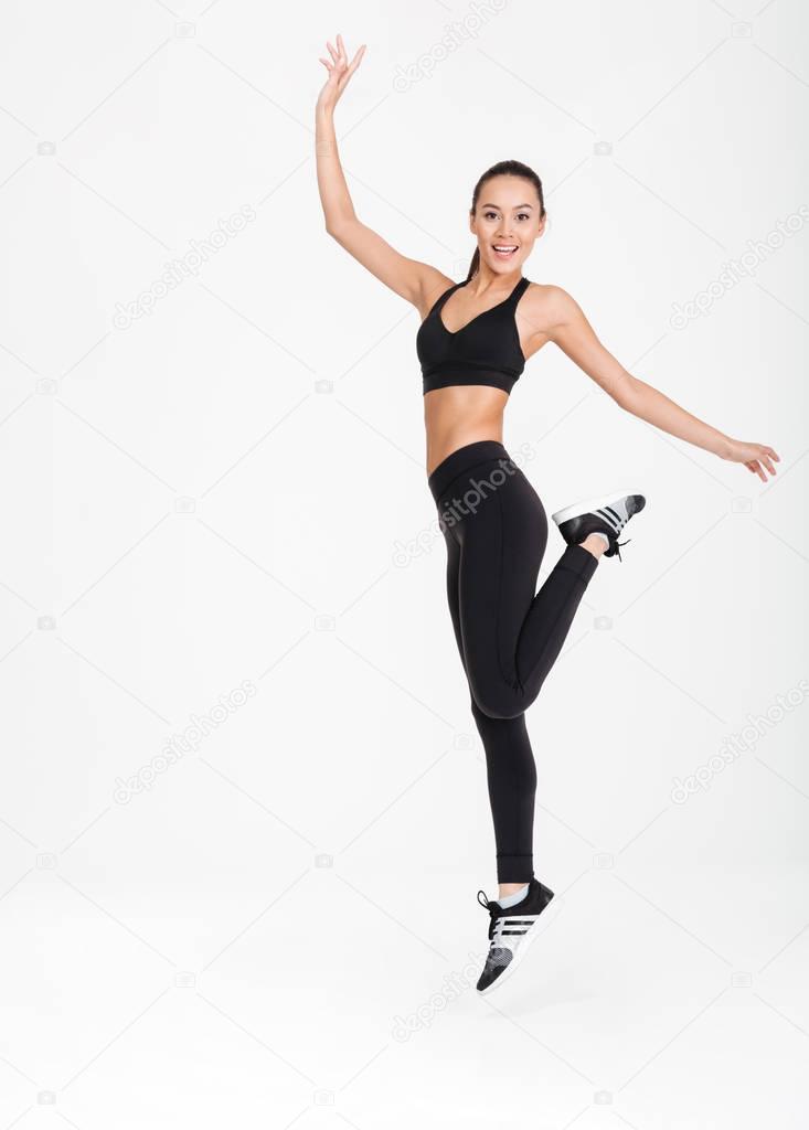 Attractive young sports woman make exercises.