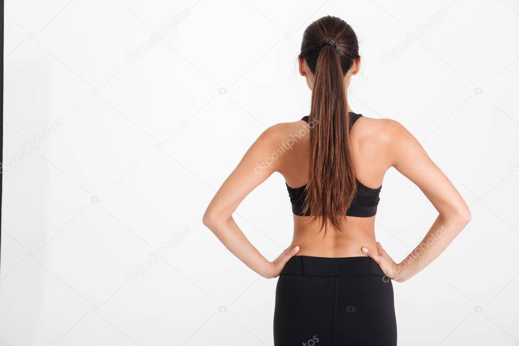 Back view portrait of a young fitness girl