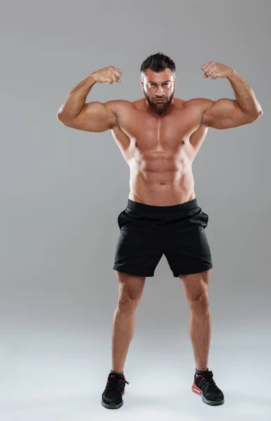 Full längd porträtt av en muskulös koncentrerad shirtless male kroppsbyggare — Stockfoto