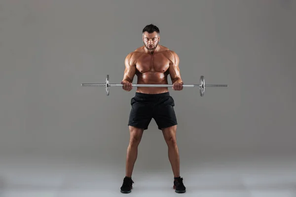 Full length portrait of a muscular strong shirtless male bodybuilder — Stock Photo, Image