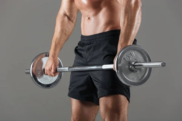 Güçlü bir üstsüz erkek vücut geliştirmeci görüntü kırpılmış yan görünüm — Stok fotoğraf
