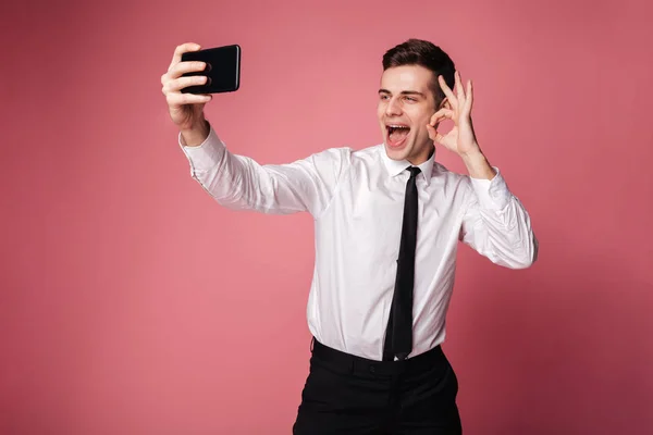 Cheerful young businessman showing okay gesture. — Stock Photo, Image