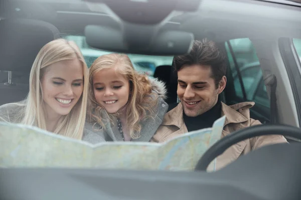Felice giovane famiglia in auto mappa . — Foto Stock