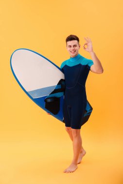 Tam boy görüntü mutlu sörfçü surfboard ile yürüyüş