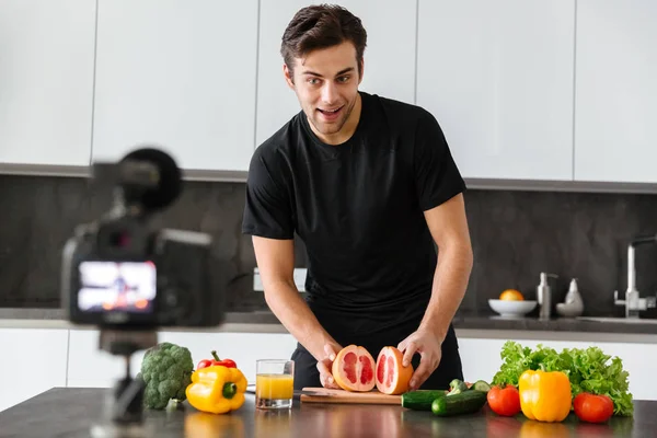 Smiling young man filming his video blog episode — Stock Photo, Image