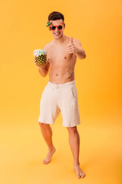 Ganzkörperbild eines lächelnden nackten Mannes in kurzen Hosen und Sonnenbrille — Stockfoto