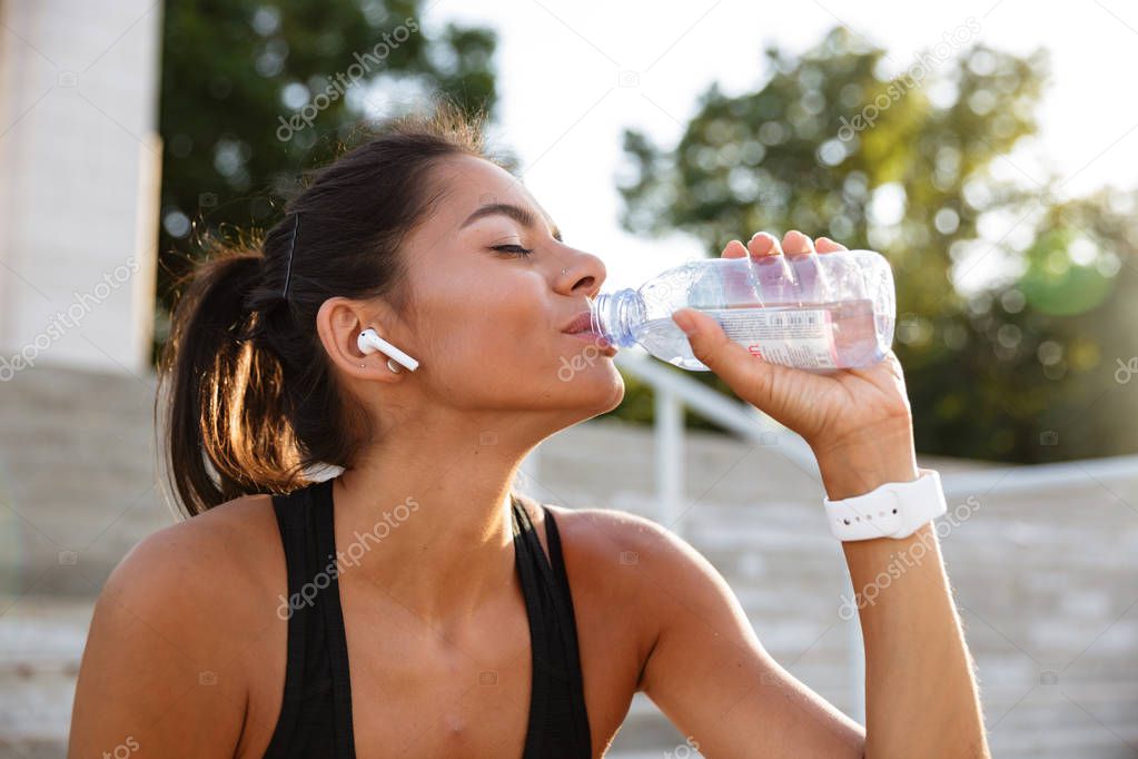 Portrait of a young fitness girl in earphones