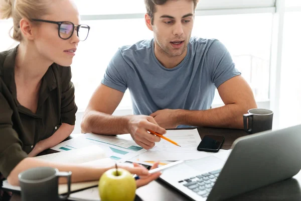 Young busy couple working at home — Stock Photo, Image