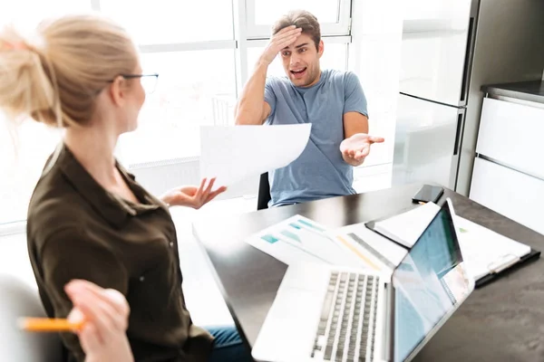 Young busy man has a quarrel with his woman while working at home — Stock Photo, Image
