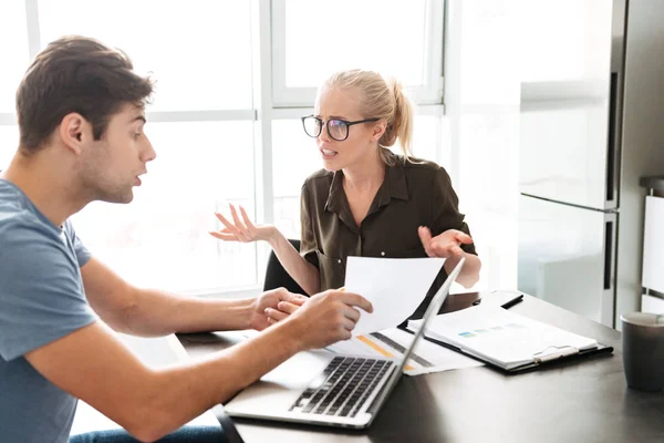 Young lady has a quarrel with her man while working with papers — Stock Photo, Image