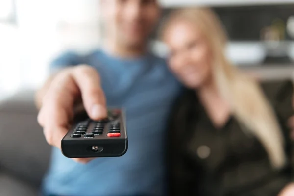 Close up of remote controller in hands of young man — Stock Photo, Image
