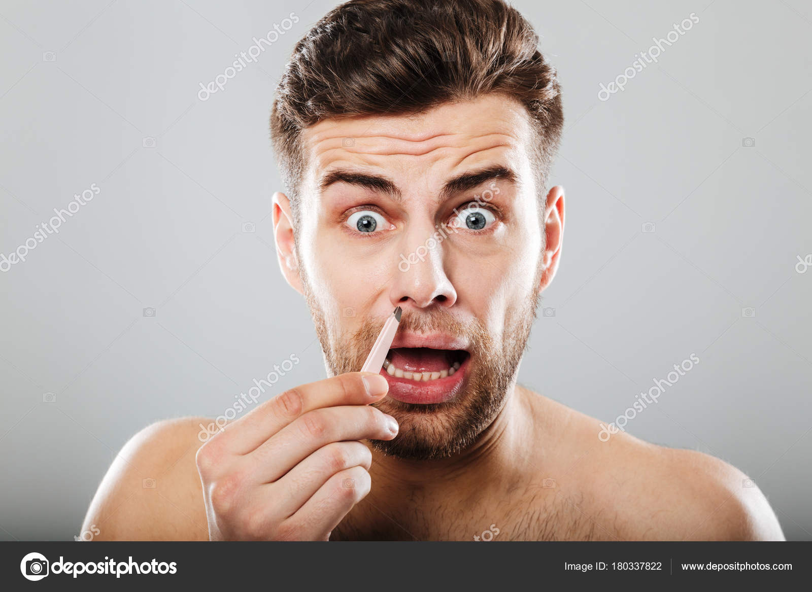 Scared Man Removing Nose Hair With Tweezers Stock Photo