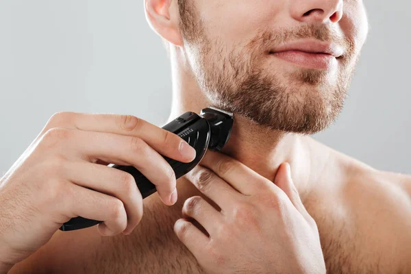 Close up portrait of a smiling man shaving his beard — Stock Photo, Image