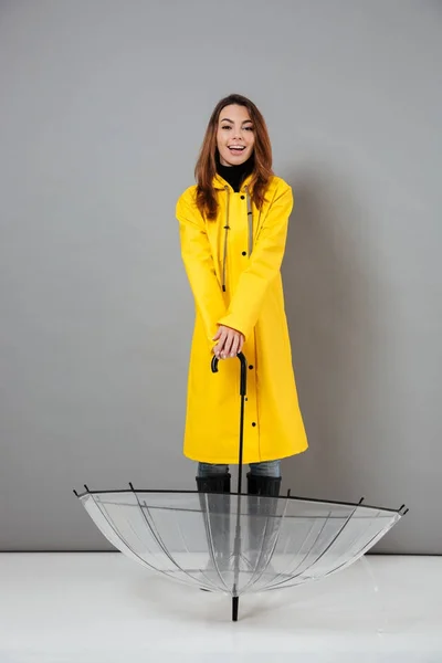 Full length portrait of a smiling girl dressed in raincoat — Stock Photo, Image