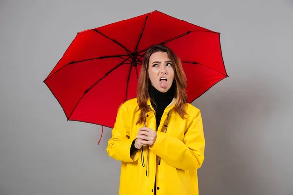Portrait of an upset girl dressed in raincoat