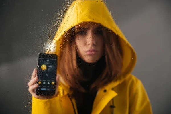 Close up of an upset girl dressed in raincoat