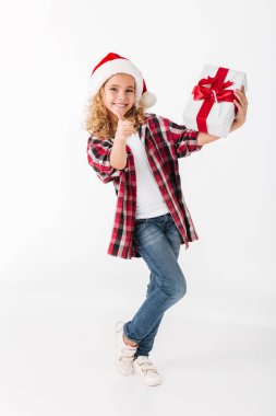 Full length portrait of a little girl holding gift box clipart