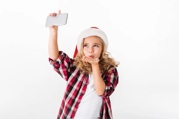 Retrato de una niña encantadora vestida con sombrero de Navidad —  Fotos de Stock