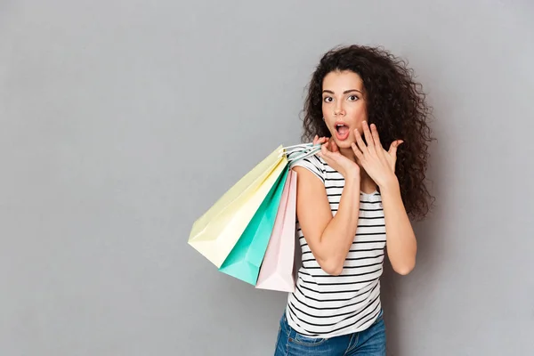 Pleased female shopaholic being excited with all purchases and p — Stock Photo, Image