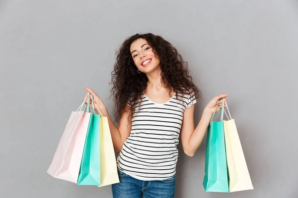 Picture of trendy fashion woman posing on camera with lots of pa — Stock Photo, Image