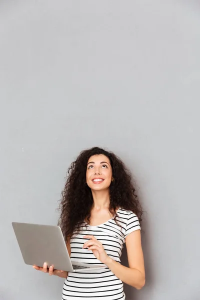 Happy lady with curly hair typing message or communicating in in — Stock Photo, Image