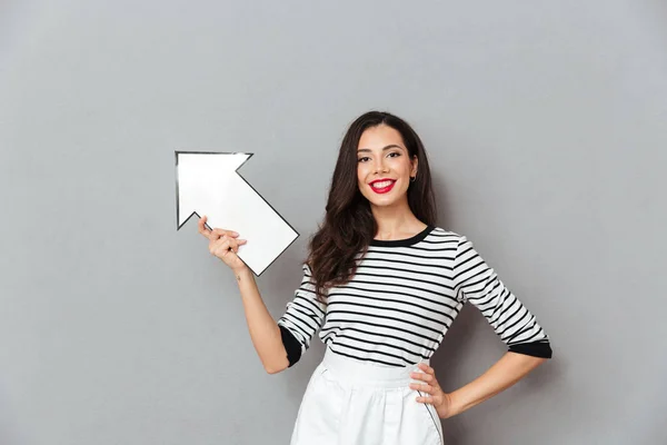 Portrait of a pretty woman pointing away — Stock Photo, Image