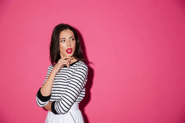 Portrait of a pensive woman posing while standing — Stock Photo, Image