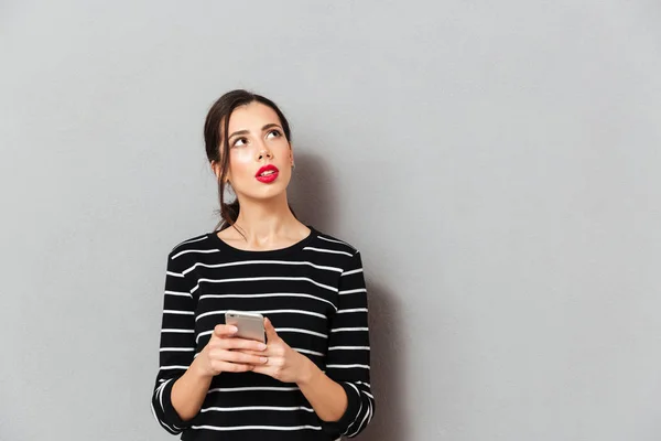 Portrait of a serious woman holding mobile phone — Stock Photo, Image