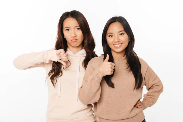 Zwei asiatische hübsche Schwestern zeigen unterschiedliche Emotionen — Stockfoto