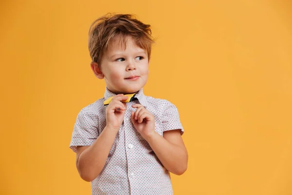 Thoughtful little boy child standing isolated — Stock Photo, Image
