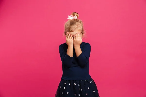 Pretty young girl covering her face while being in studio — Stock Photo, Image