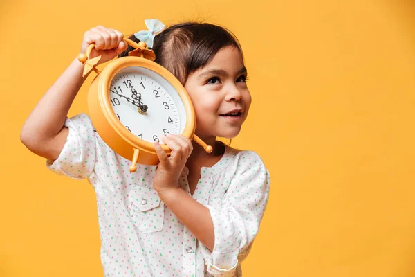 Cheerful little girl holding clock alarm. — Stock Photo, Image