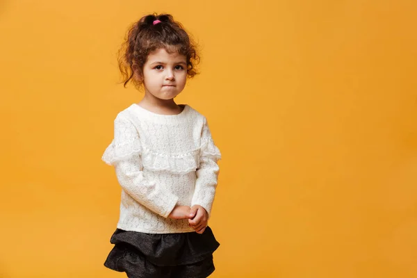 Confused little girl child standing isolated — Stock Photo, Image
