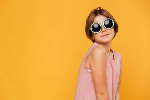 Confident serious girl in sunglasses looking aside — Stock Photo, Image