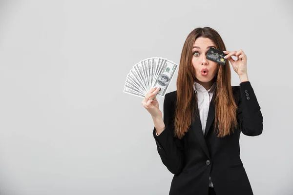 Funny lady grimacing and holding cash and credit card in hands — Stock Photo, Image