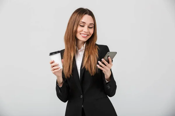 Handsome delightful lady using smartphone and holding coffee isolated — Stock Photo, Image