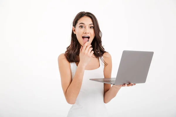 Portrait of an excited girl dressed in tank-top using laptop — Stock Photo, Image
