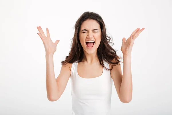 Portrait of a furious girl dressed in tank-top screaming — Stock Photo, Image