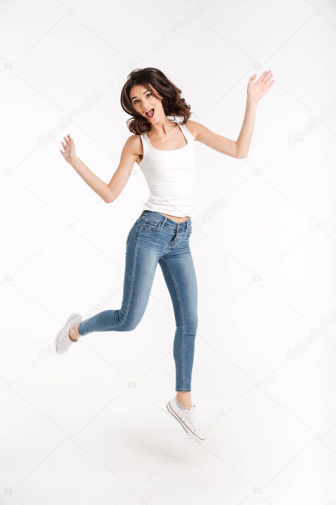 Full length portrait of an excited girl dressed in tank-top